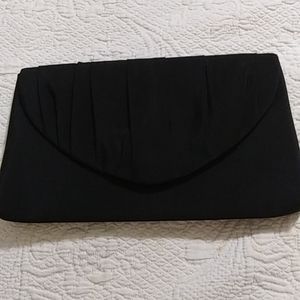 Black satin evening clutch with cord to wear on shoulder or not. In good conditi